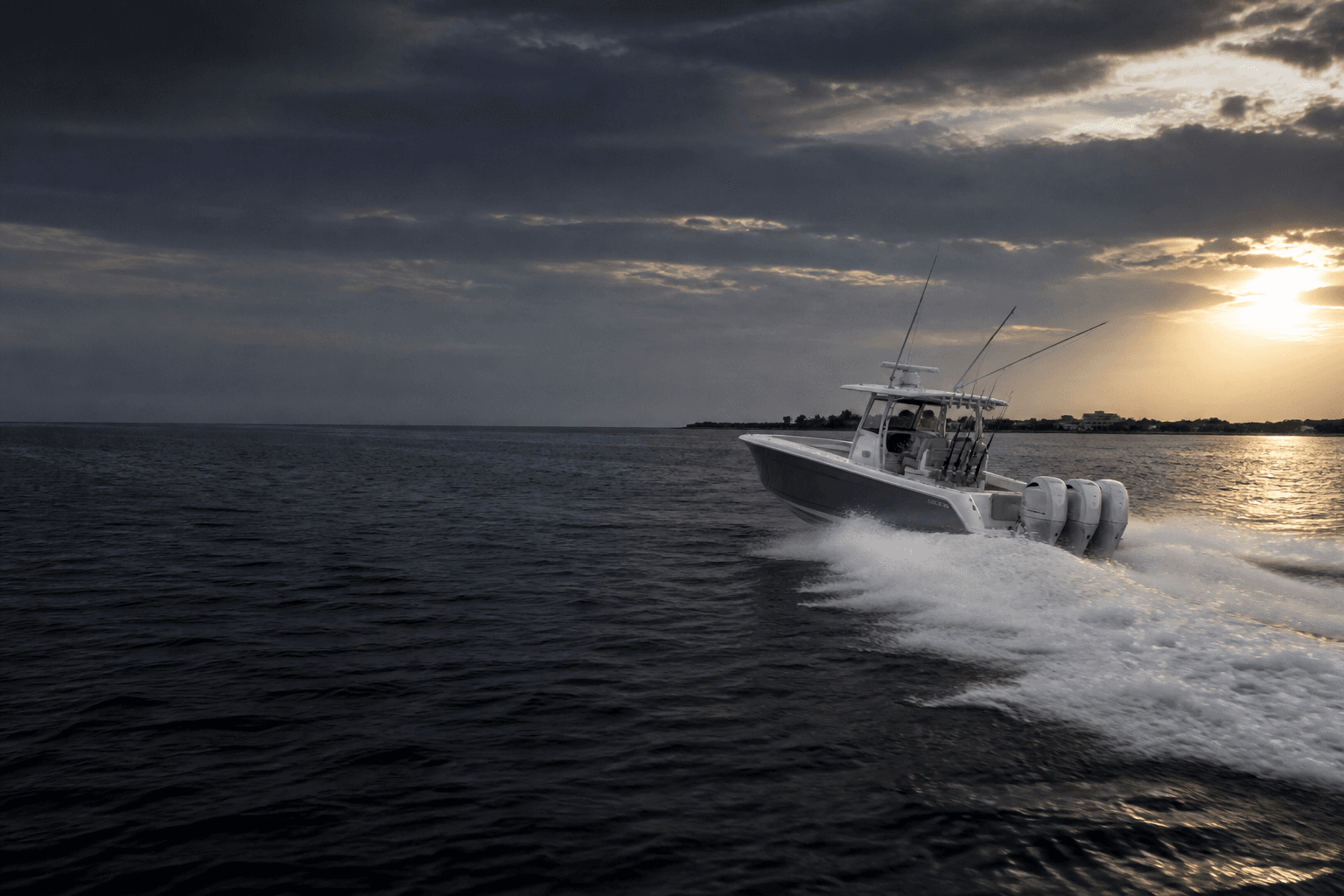 Offshore powerboat cutting a clean wake across open coastal water